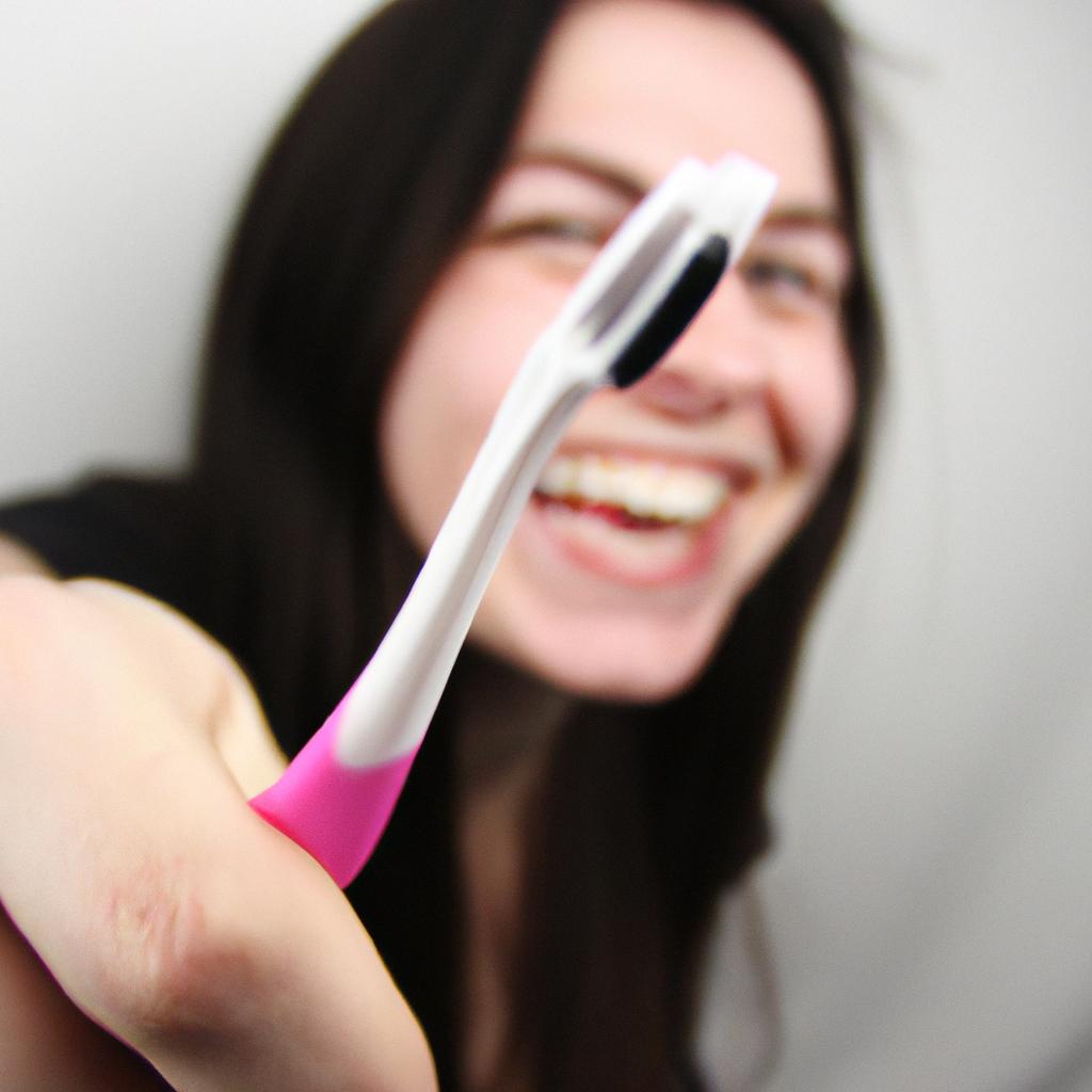 Person holding a toothbrush, smiling